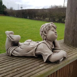 Border Stoneware Laying Boy With Book